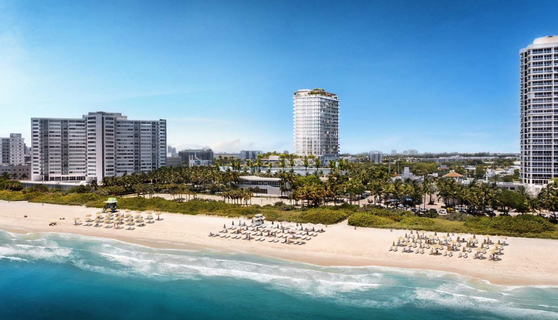 Beachfront with rows of umbrellas along white-sand shore and turquoise water, hotel high-rises in the background under a clear blue sky.