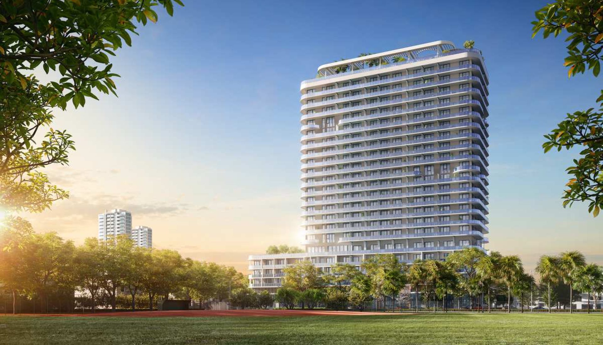 Modern high-rise residential tower with curved balconies set in a landscaped park at sunset; sunlight glints off the glass facade