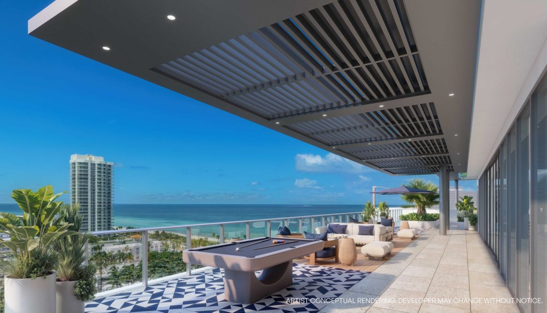 Rooftop terrace with a modern pool/billiards table, lounge seating, and a blue ocean view beyond a glass railing.
