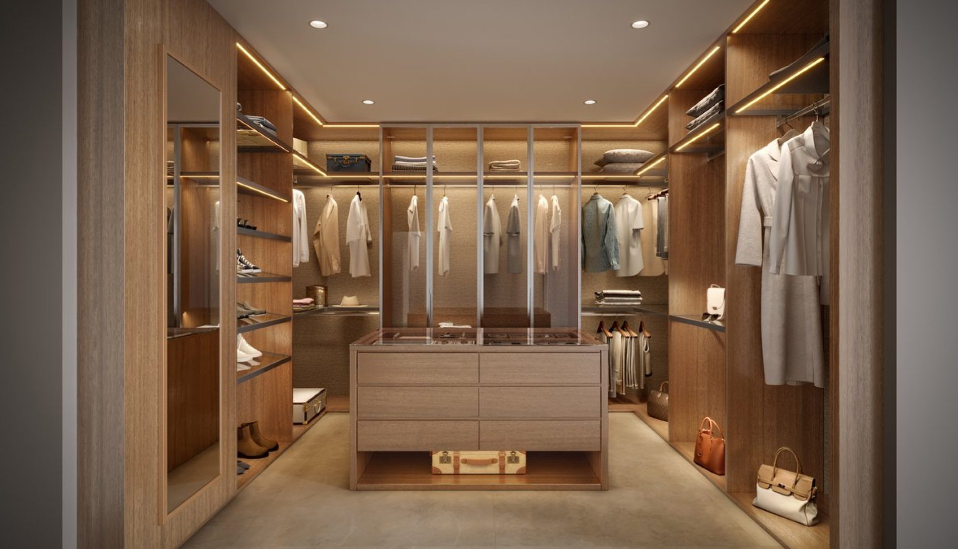 Luxurious wooden walk-in closet with hanging clothes, shelves, and a central dresser illuminated by warm lights.