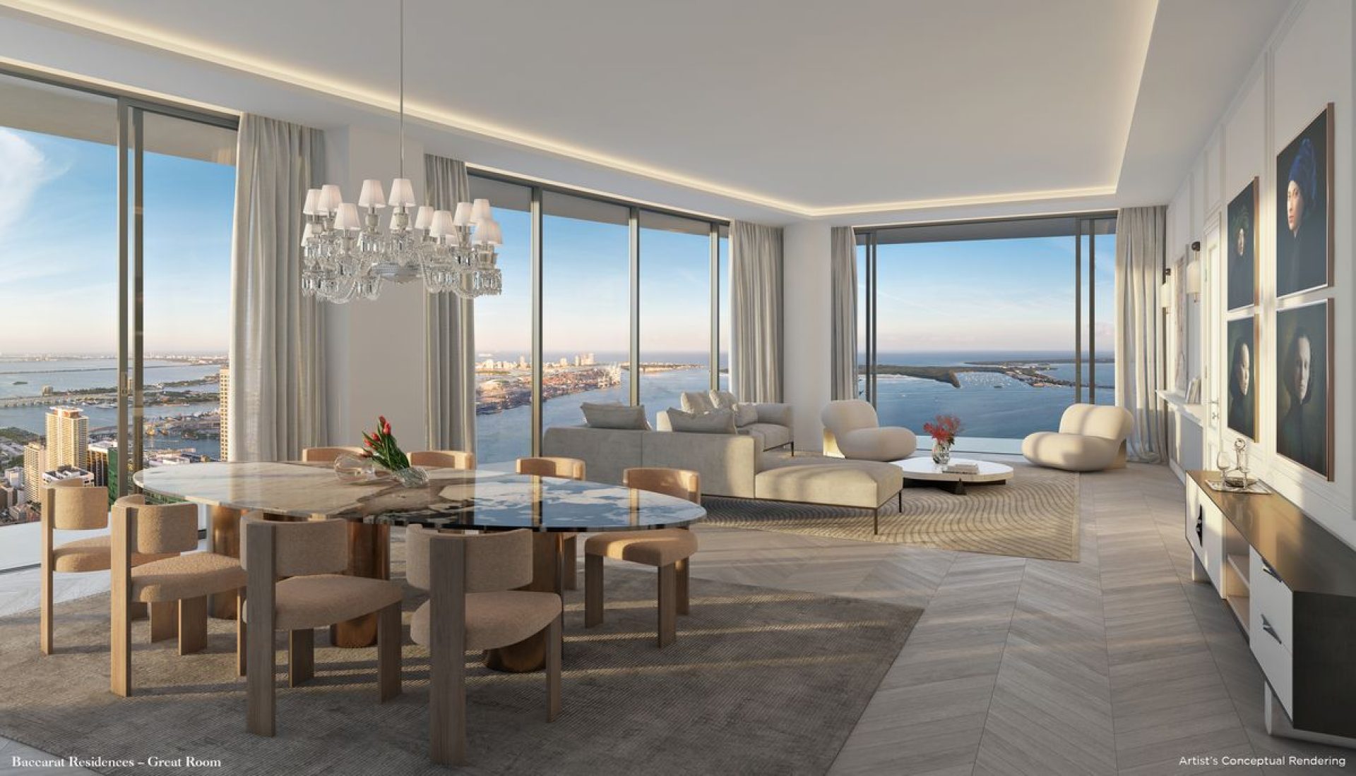 Open-concept living and dining area with a round marble dining table, beige chairs, and a panoramic ocean and city view through floor-to-ceiling windows.