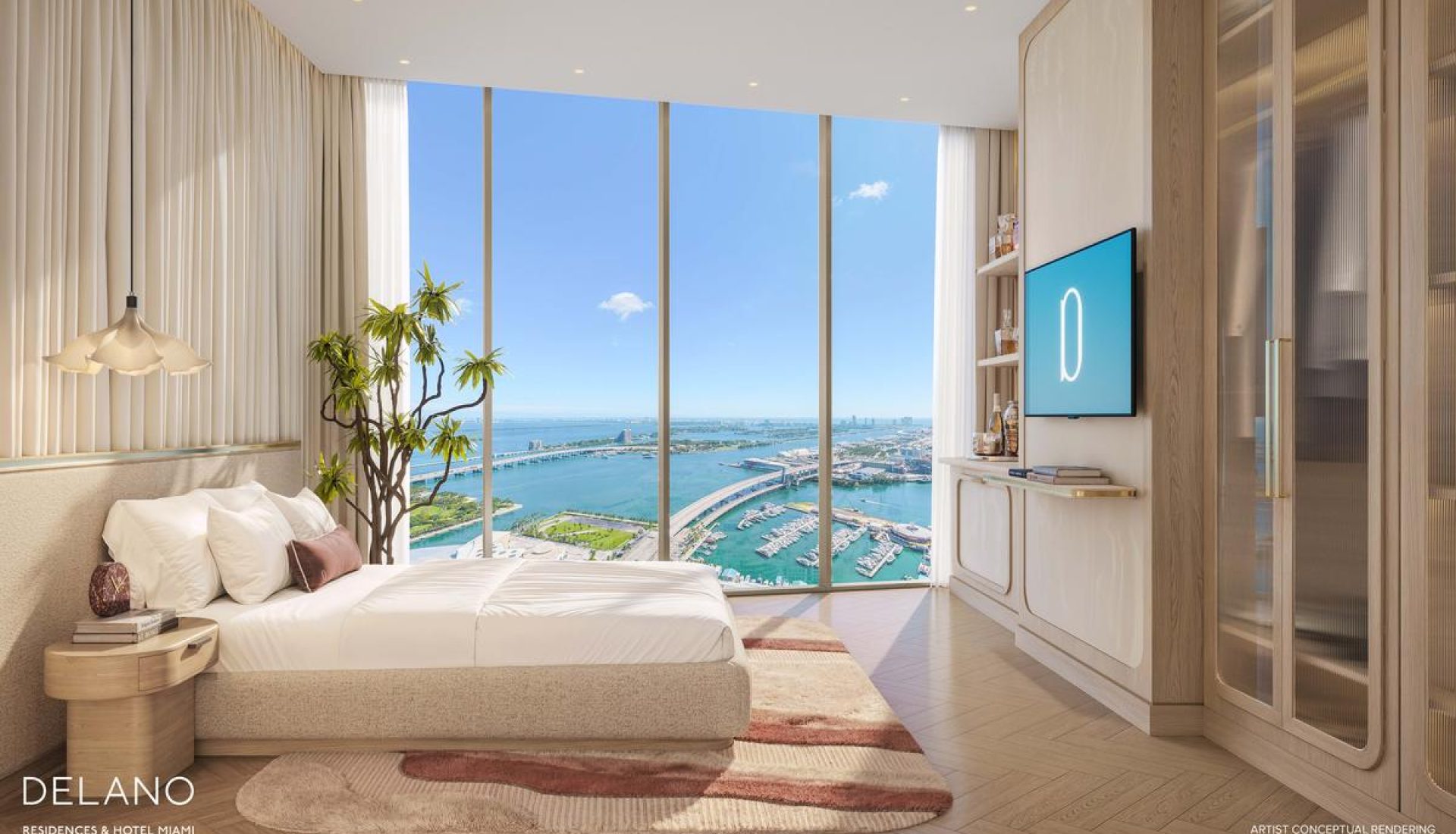 Luxurious bedroom with a low-profile bed facing floor-to-ceiling windows that overlook a marina and blue ocean, with a potted plant and soft rug in warm tones.