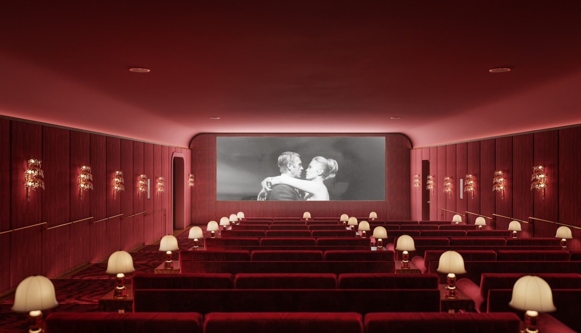 Red-dominated classic cinema interior with velvet seats and table lamps, showing a black-and-white romantic scene on the screen.