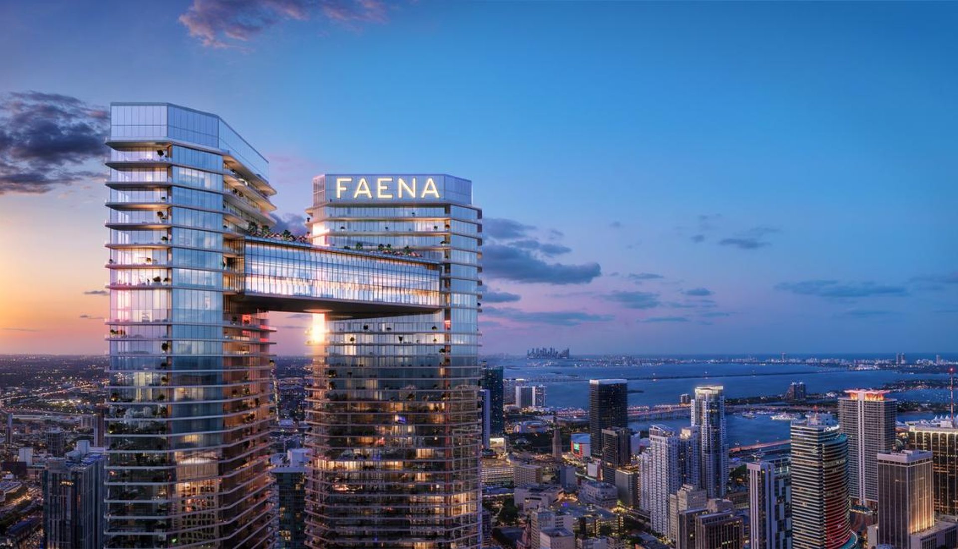 Two connected glass towers with a glowing FAENA sign above a city skyline at sunset/dusk.
