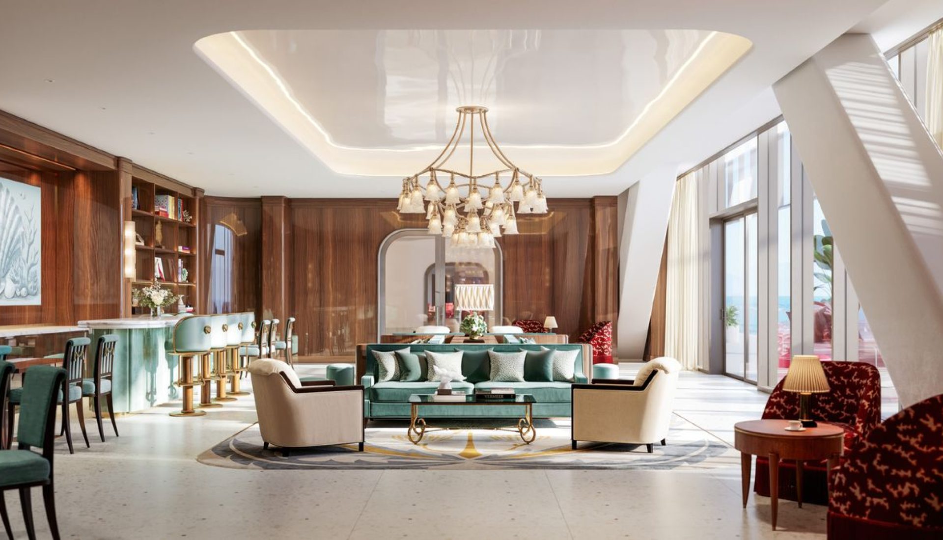 Luxurious hotel lounge with teal sofa, cream chairs, a gold chandelier; a bar and large ocean-view windows.