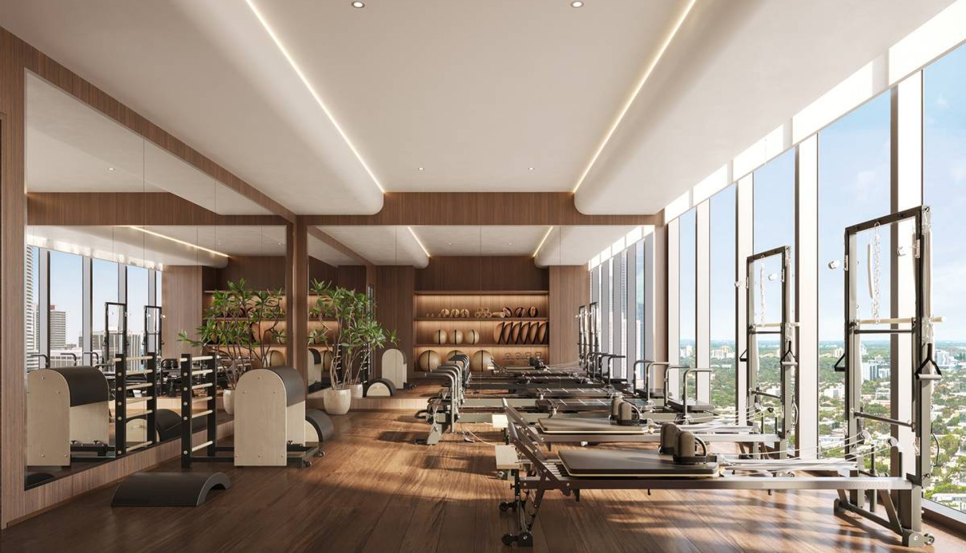 Bright, spacious gym with cardio and strength machines along floor-to-ceiling windows and a city view.