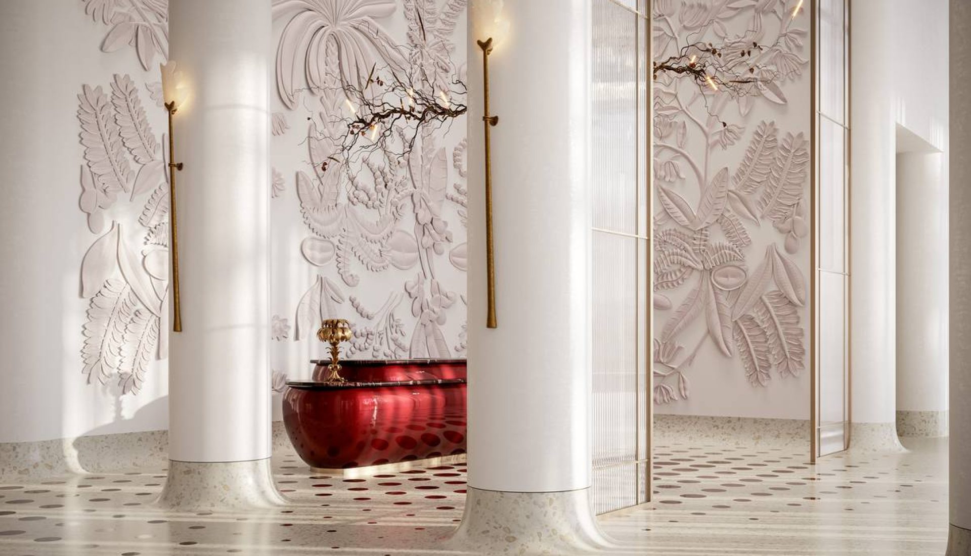 Luxurious lobby with white columns, botanical wall reliefs, and a red glossy tub centerpiece.