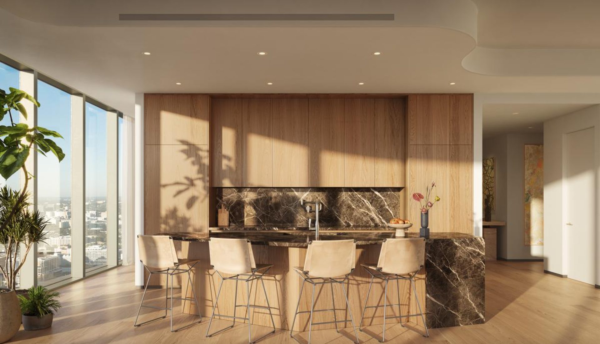 Modern kitchen with a marble island and wooden cabinets, bright natural light from floor-to-ceiling windows, and beige bar stools around the island.