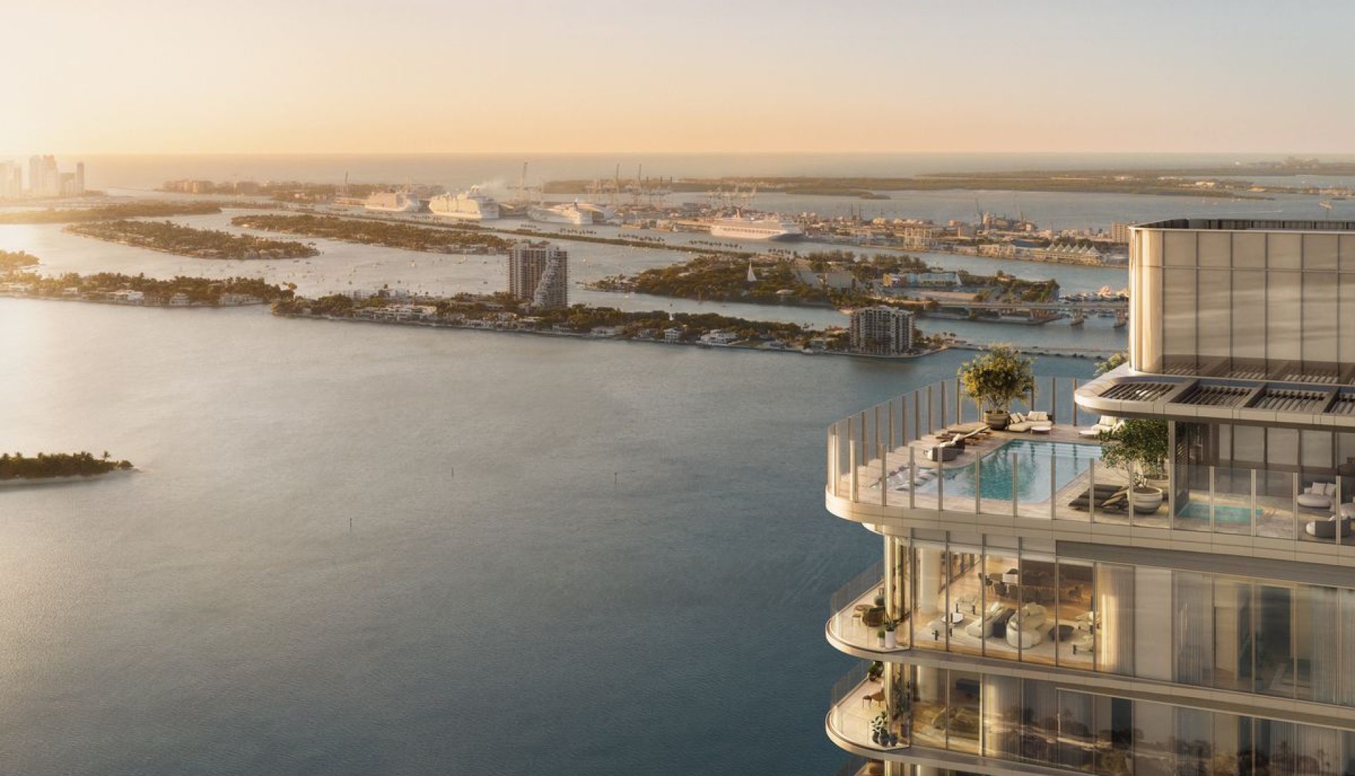 Luxurious glass-clad high-rise terrace with a pool and lounge area, overlooking a calm coastal city at sunset