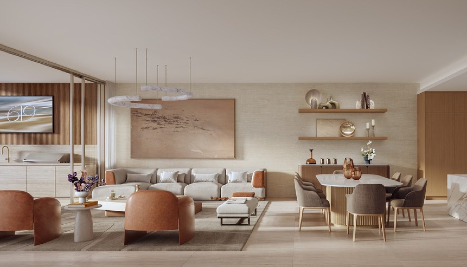 Open-concept living space with a gray sofa, orange-brown chairs, and a marble kitchen island, plus a balcony with an ocean view.