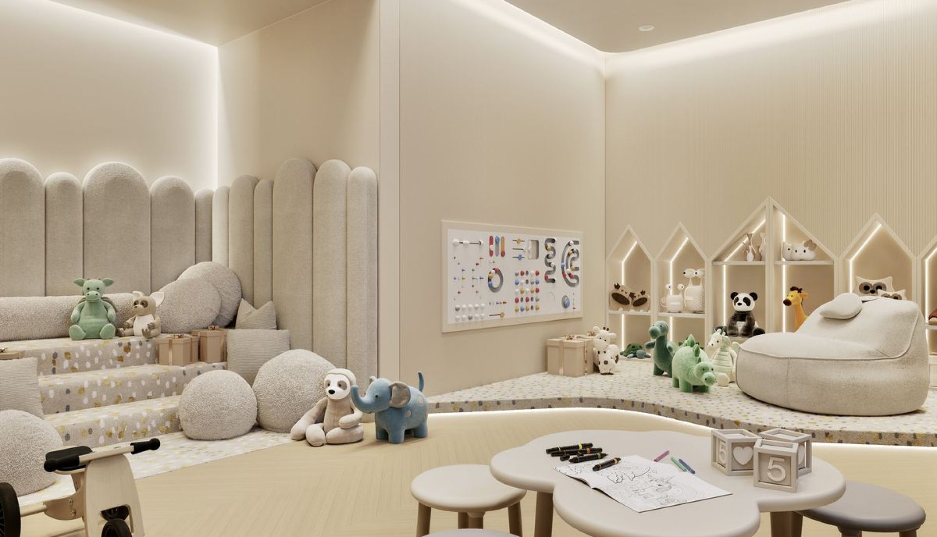Bright neutral children’s playroom with soft beige seating, stuffed animals, and a round craft table for activities.