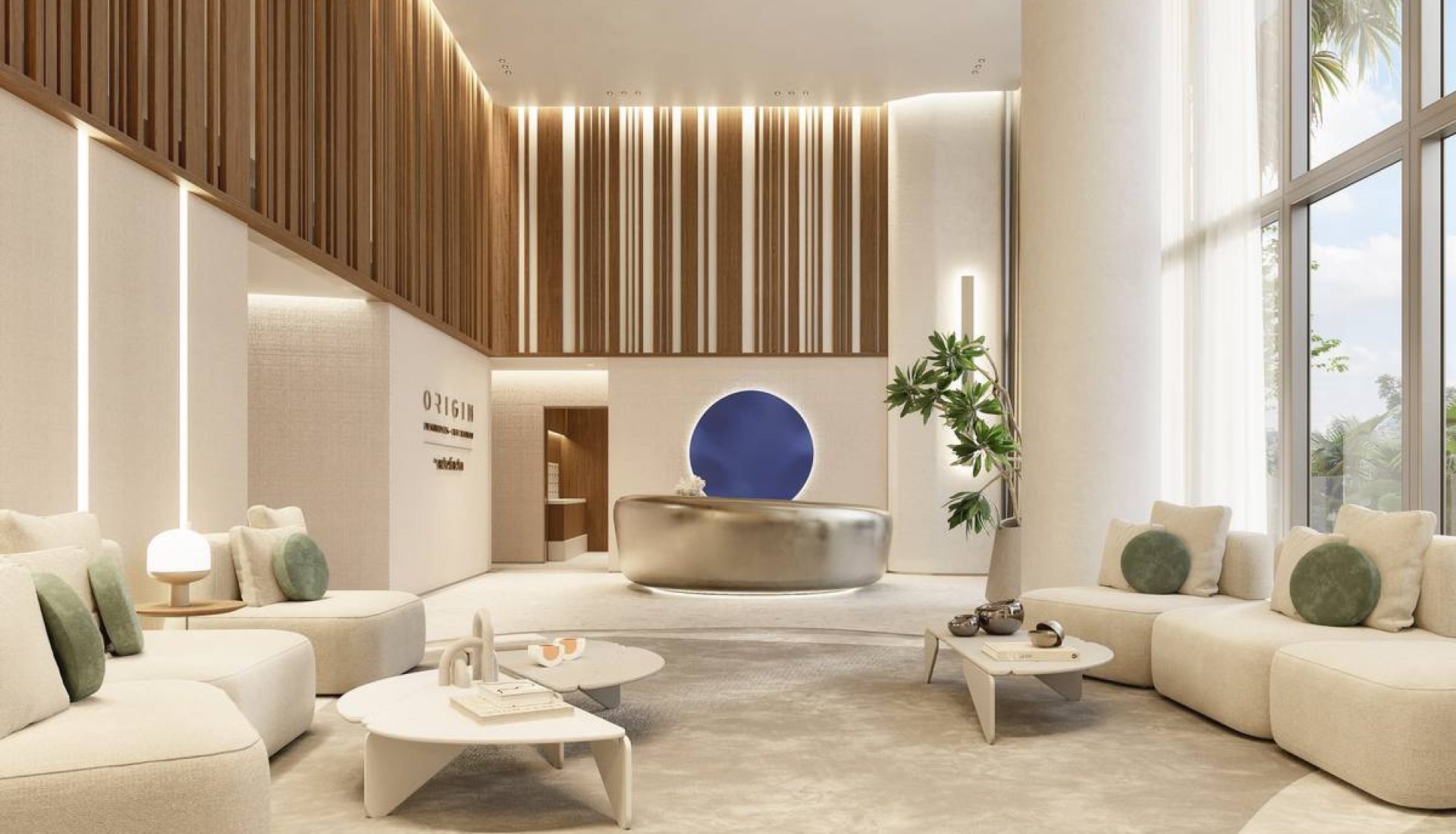 Modern hotel lobby with cream curved sofas, circular coffee tables, and a reception desk featuring a blue circular art piece.