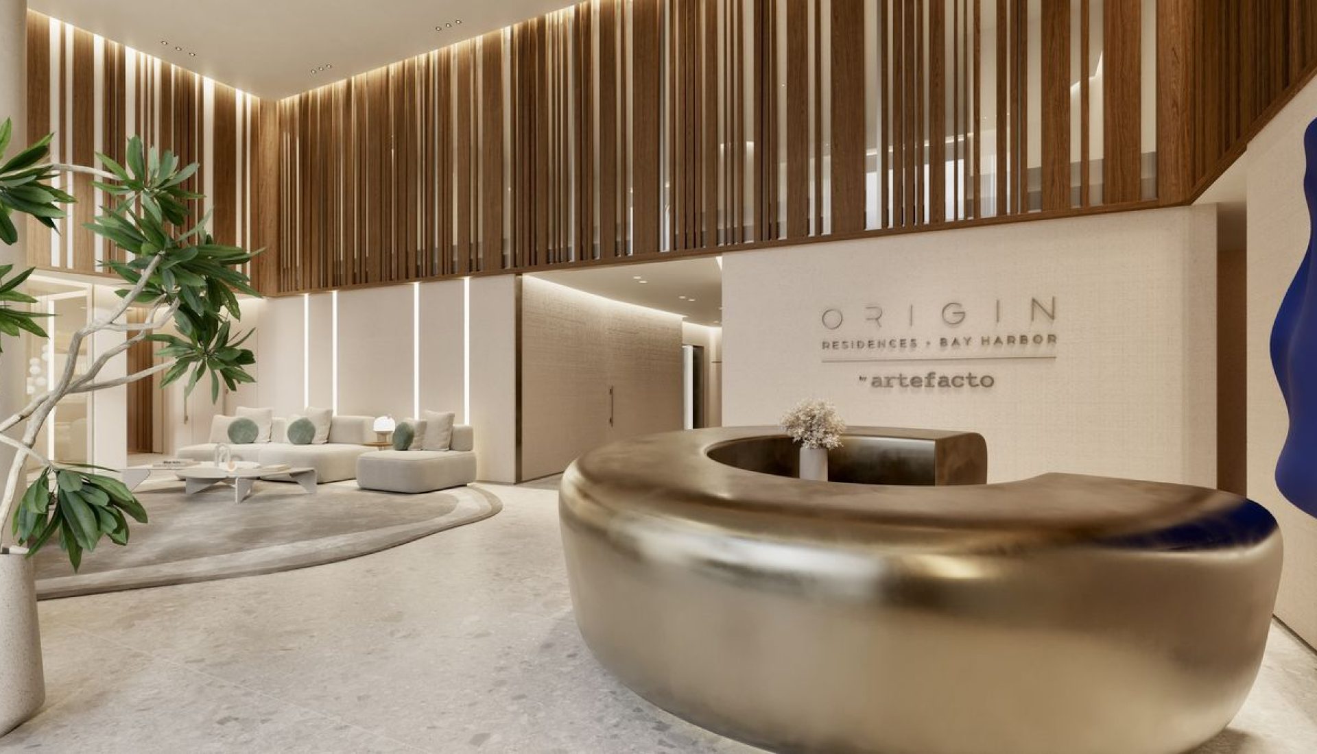 Luxurious hotel lobby with a large curved bronze reception bench, warm lighting, and a white textured wall reading 'Origin Residences Bay Harbor'.