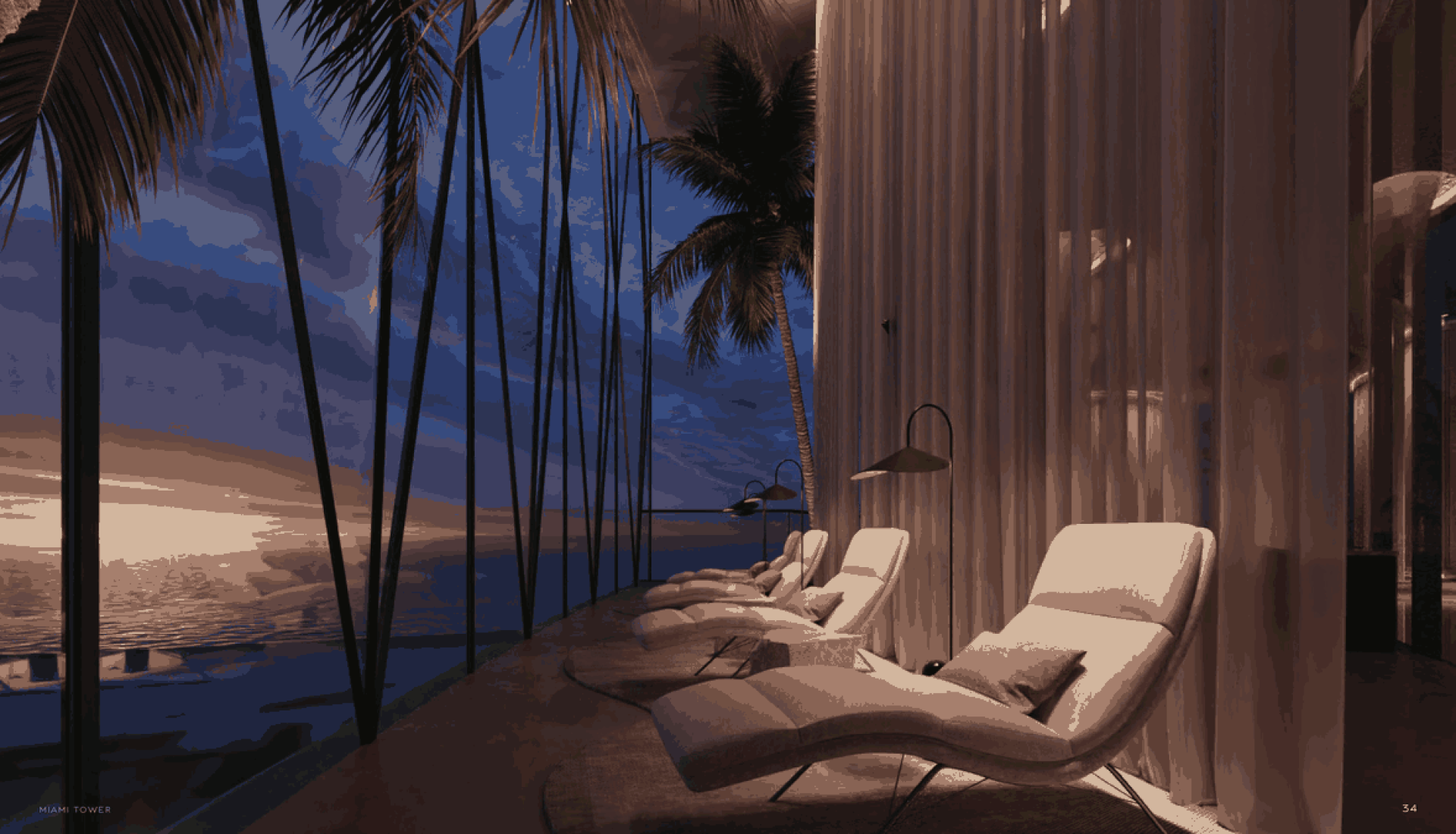 Luxurious beachside lounge with white chaise lounges facing a sunset over the ocean.