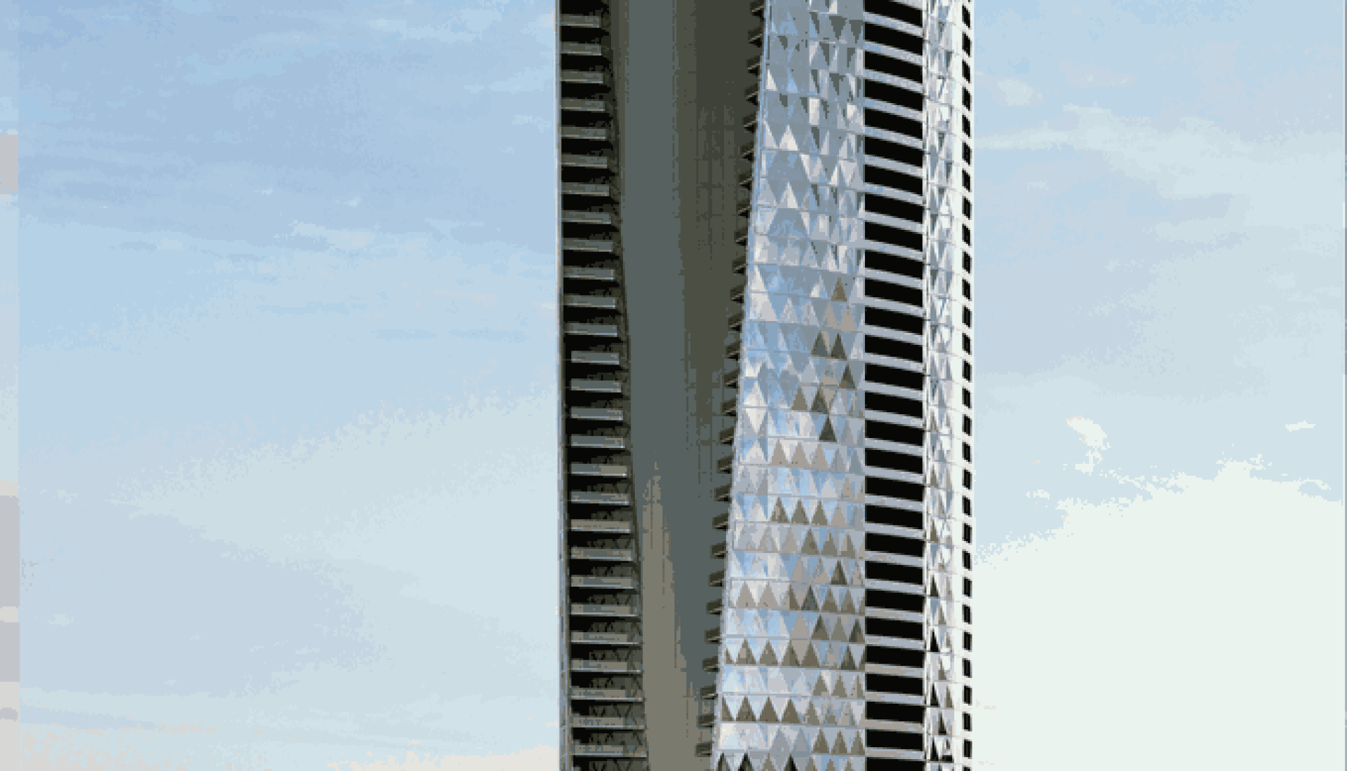Tall modern skyscraper with a diamond-patterned glass facade beside the sea, under a blue sky.