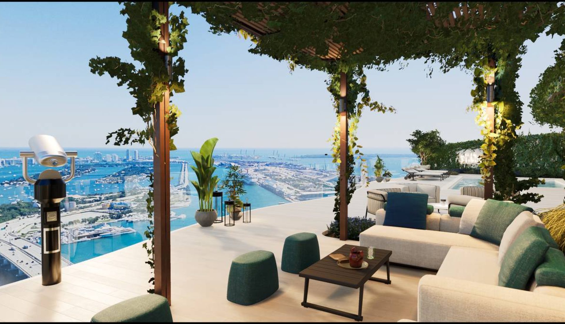 Outdoor terrace with beige sectional seating, green cushions, and a low table overlooking a harbor and the ocean.