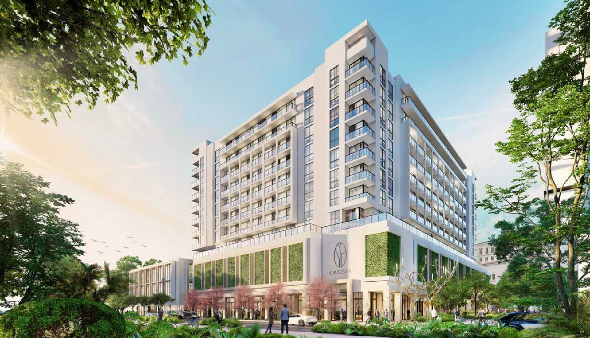 Rendering of a modern, multi-story mixed-use building with a green-walled retail podium and glass balconies, set among trees.
