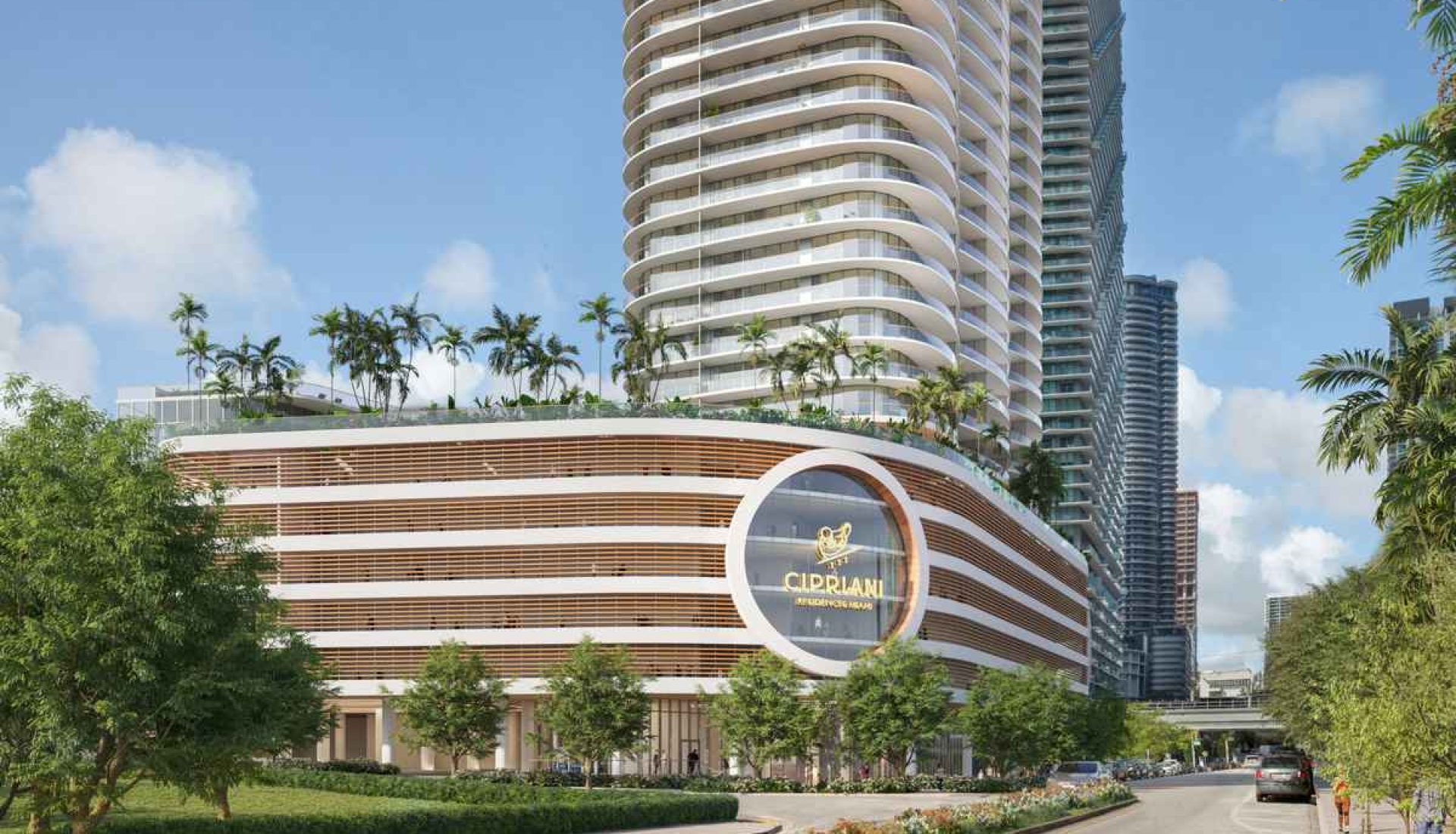 Modern hotel/residential complex with curved white balconies and a circular glass emblem on the façade, set against a tall high-rise and palm trees.