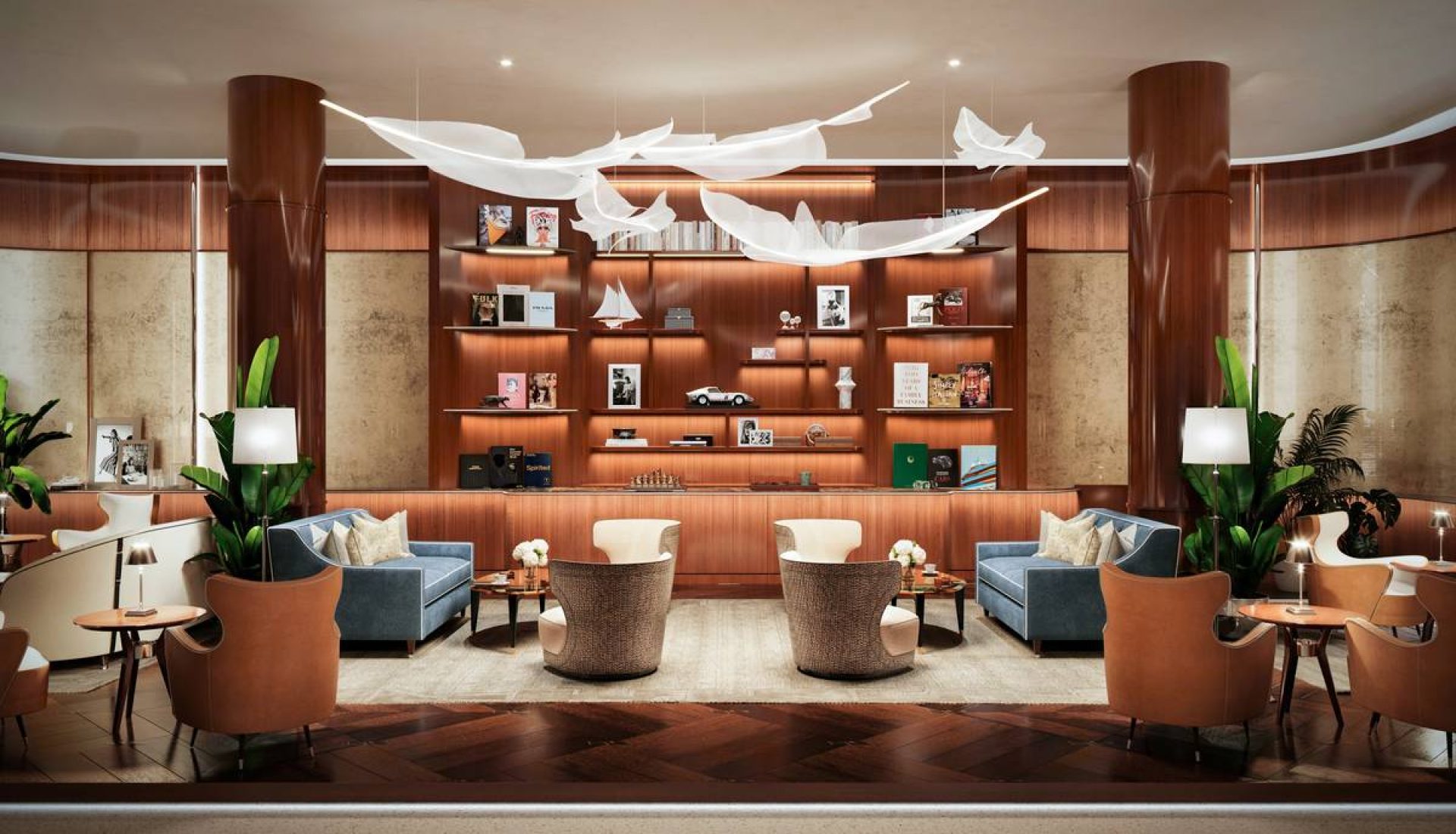 Luxurious hotel lobby lounge with blue sofas, wicker chairs, and warm wood shelving displaying books and decor under white sculptural chandeliers.