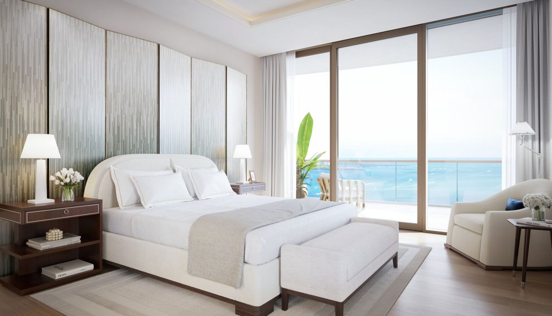 Luxurious hotel bedroom with a large white bed, two nightstands, lamps, and a sea-view balcony.