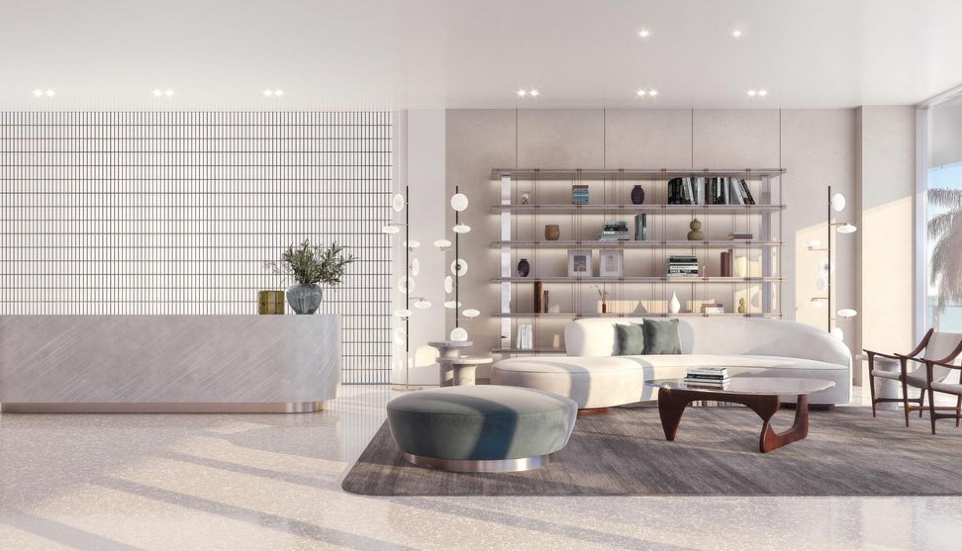Bright modern living room/lounge with a white curved sofa, round ottoman, wooden coffee table, and open shelving, viewed through floor-to-ceiling windows with an ocean view.